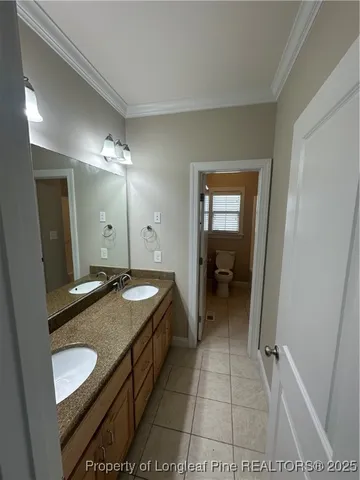 a bathroom with a granite countertop sink a light fixture and a mirror