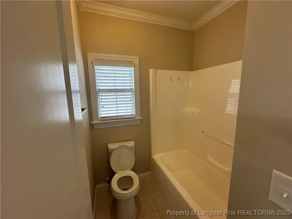 a bathroom with a granite countertop sink a light fixture and a mirror