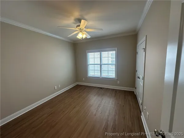 a view of an empty room with wooden floor
