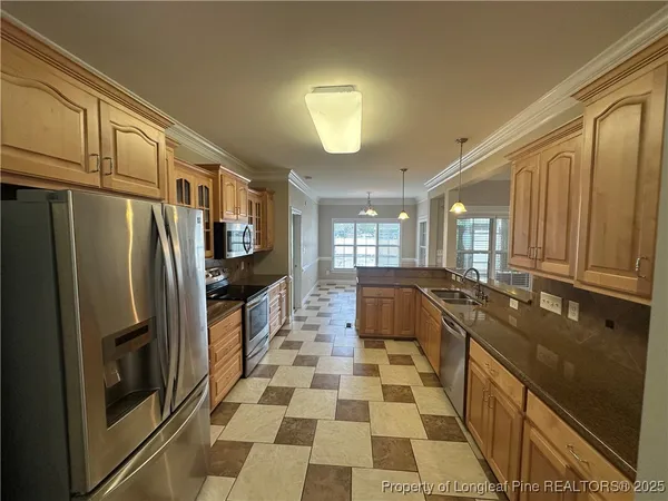 a kitchen with a sink a counter and cabinets