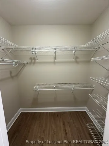 a bathroom with a bathtub and a double vanity sink a toilet