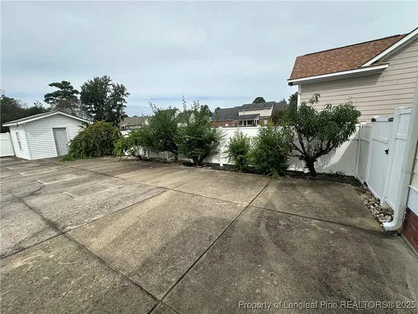 a view of a house with a small yard and garage