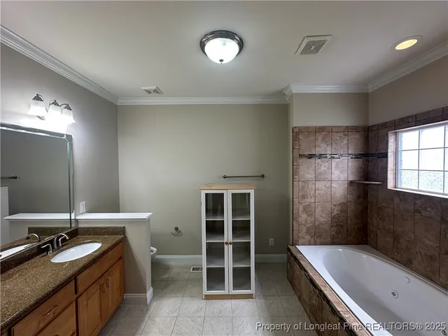 a bathroom with a tub sink and mirror