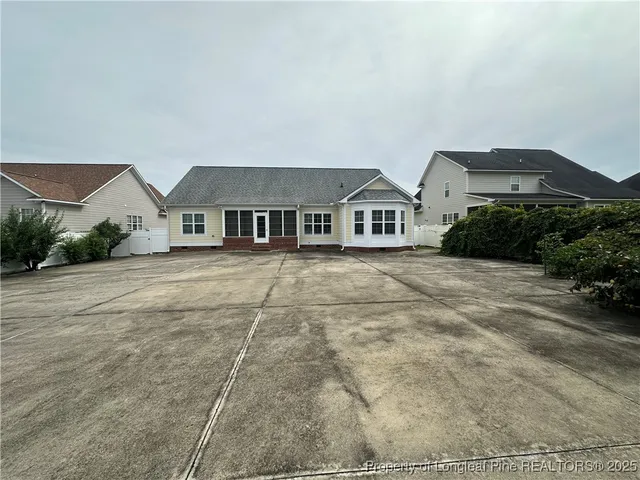 a view of a house with a backyard