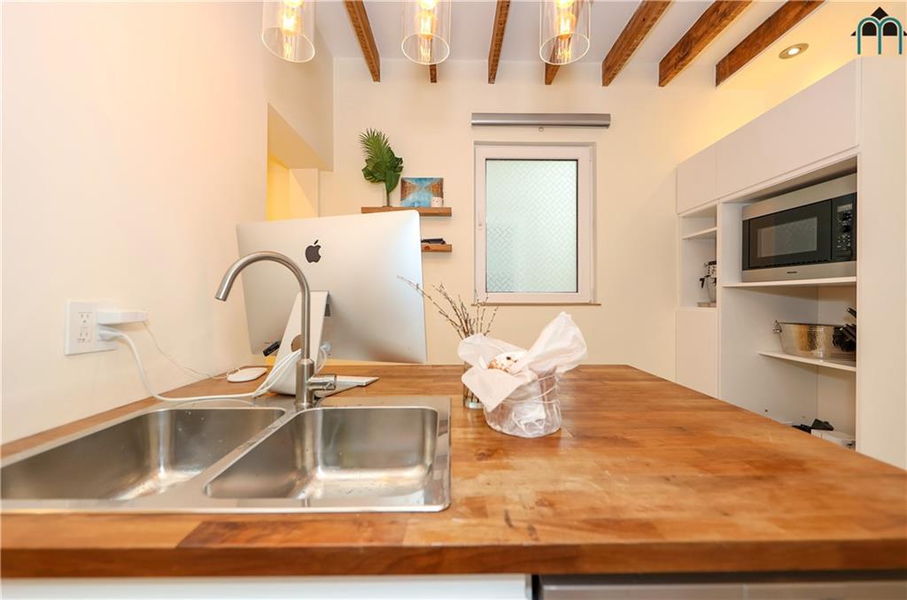 2 Brighton 4th Road Brooklyn, NY 11235 - Photo 12 of 31 a kitchen with a sink and a microwave