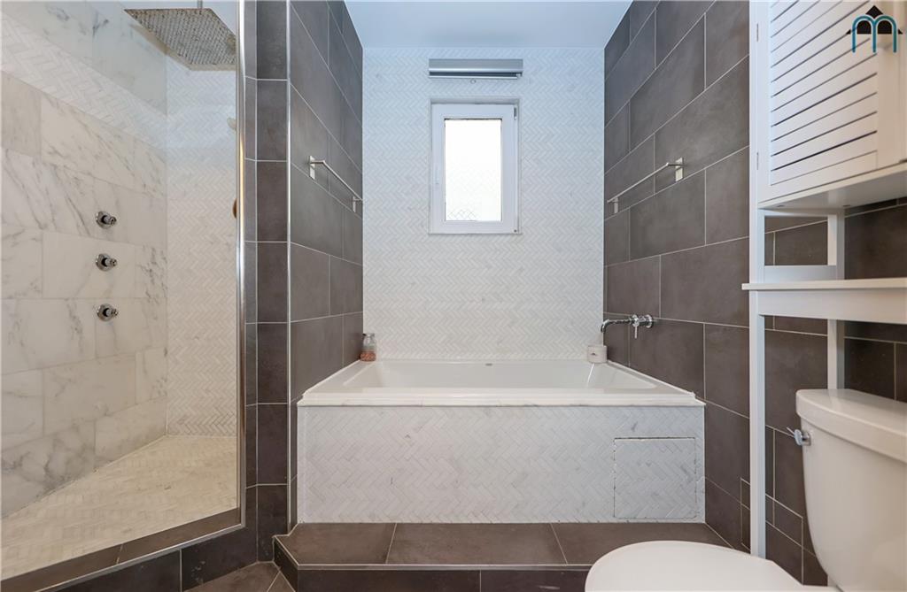 2 Brighton 4th Road Brooklyn, NY 11235 - Photo 16 of 31 a bathroom with a sink toilet and shower