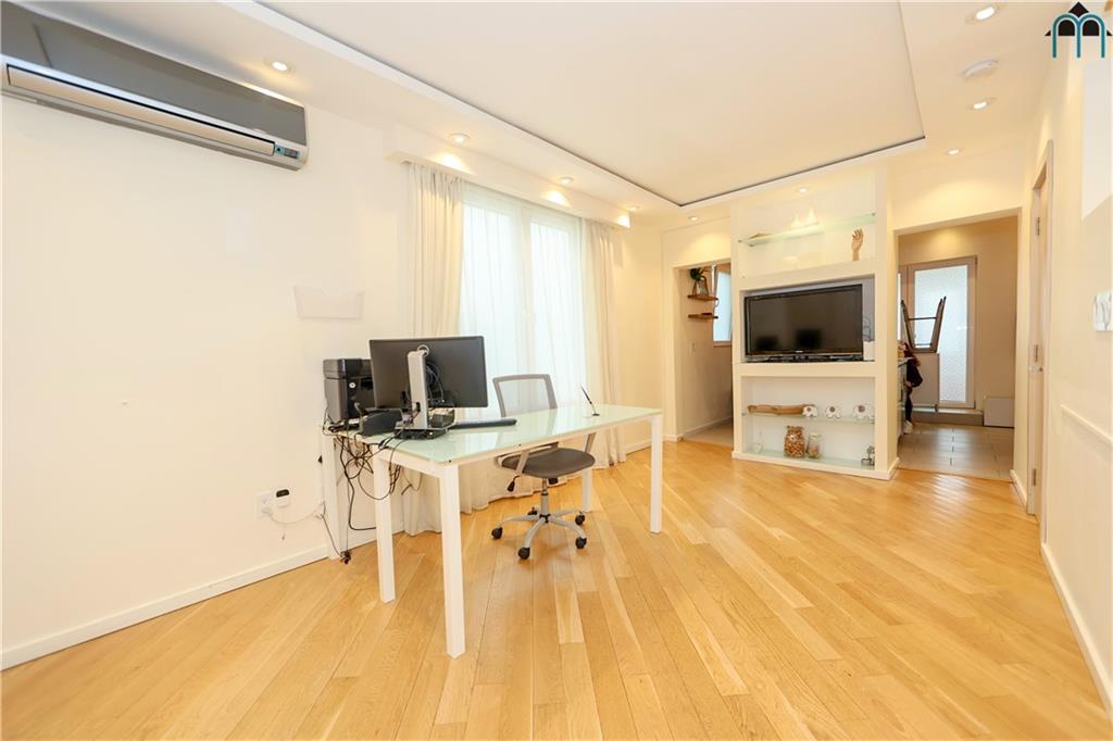 2 Brighton 4th Road Brooklyn, NY 11235 - Photo 23 of 31 a living room with furniture and flat screen tv