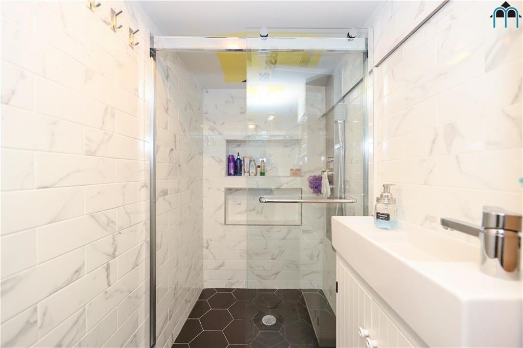 2 Brighton 4th Road Brooklyn, NY 11235 - Photo 25 of 31 a bathroom with a sink a toilet and shower