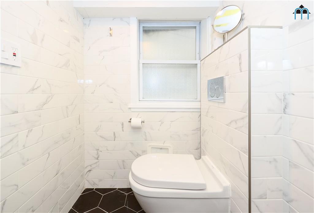 2 Brighton 4th Road Brooklyn, NY 11235 - Photo 26 of 31 a bathroom with a toilet and a shower