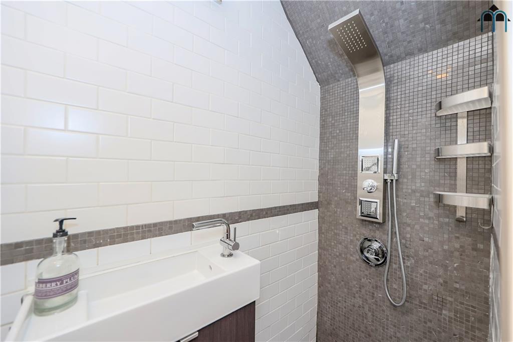 2 Brighton 4th Road Brooklyn, NY 11235 - Photo 8 of 31 a bathroom with a bathtub and shower