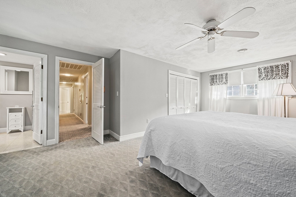 5 Lehan Street Canton, MA 02021 - Photo 15 of 27 a spacious bedroom with a large bed chandelier and closet