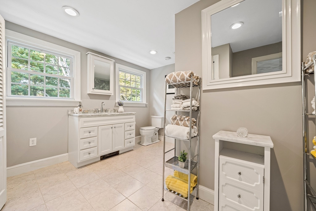 5 Lehan Street Canton, MA 02021 - Photo 16 of 27 a bathroom with a sink a vanity and a mirror