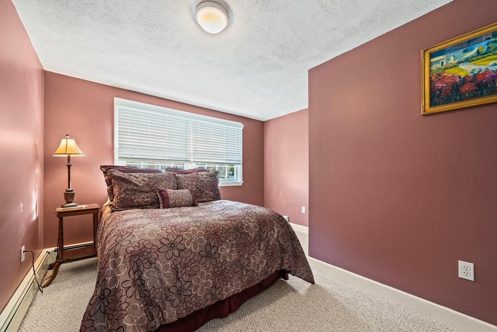 5 Lehan Street Canton, MA 02021 - Photo 18 of 27 a bedroom with a bed and painting on the wall