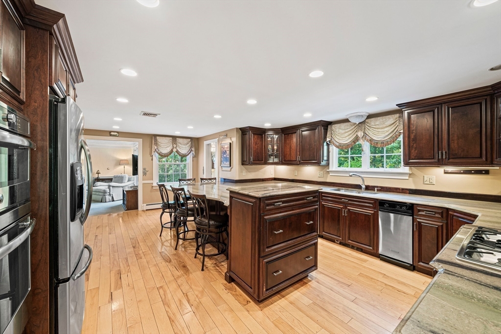 5 Lehan Street Canton, MA 02021 - Photo 8 of 27 a kitchen with stainless steel appliances granite countertop a stove and a refrigerator