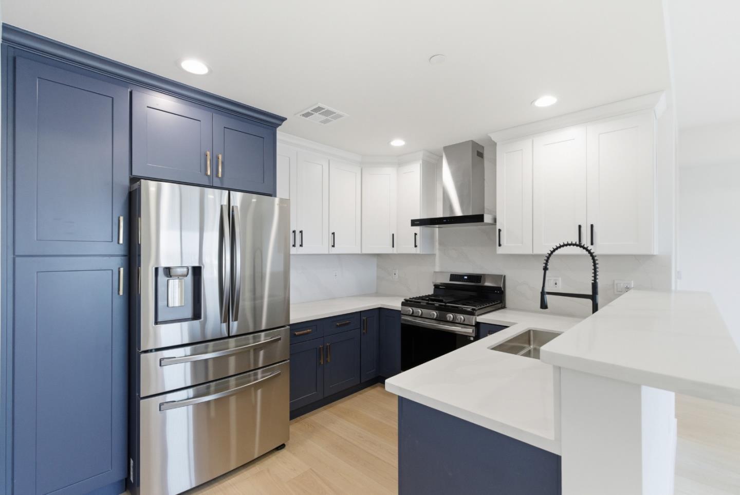 560 El Camino Real, Unit 406 San Carlos, CA 94070 - Photo 14 of 48 a kitchen with stainless steel appliances a refrigerator sink and cabinets