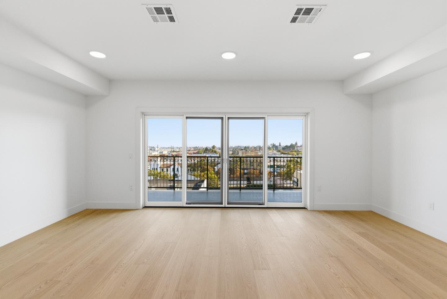 560 El Camino Real, Unit 406 San Carlos, CA 94070 - Photo 18 of 48 an empty room with wooden floor and windows