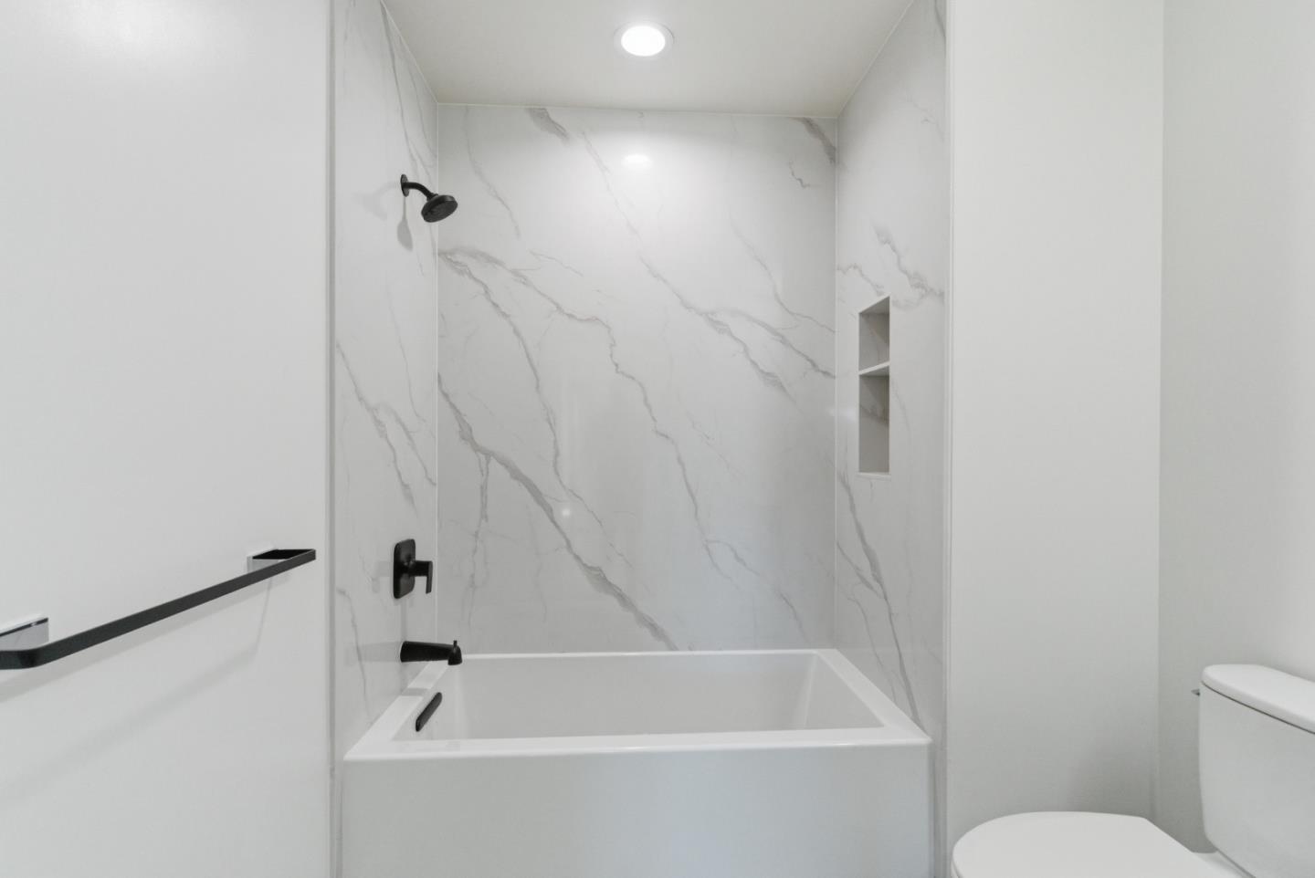 560 El Camino Real, Unit 406 San Carlos, CA 94070 - Photo 23 of 48 a bathroom with a bathtub and a toilet