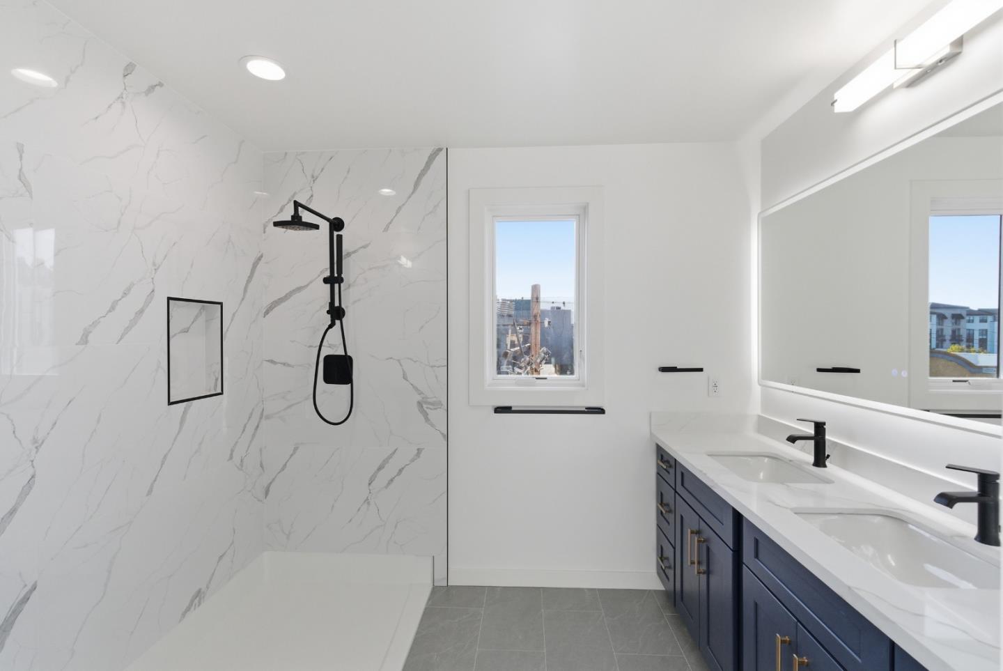 560 El Camino Real, Unit 406 San Carlos, CA 94070 - Photo 28 of 48 a bathroom with a double vanity sink a mirror and shower