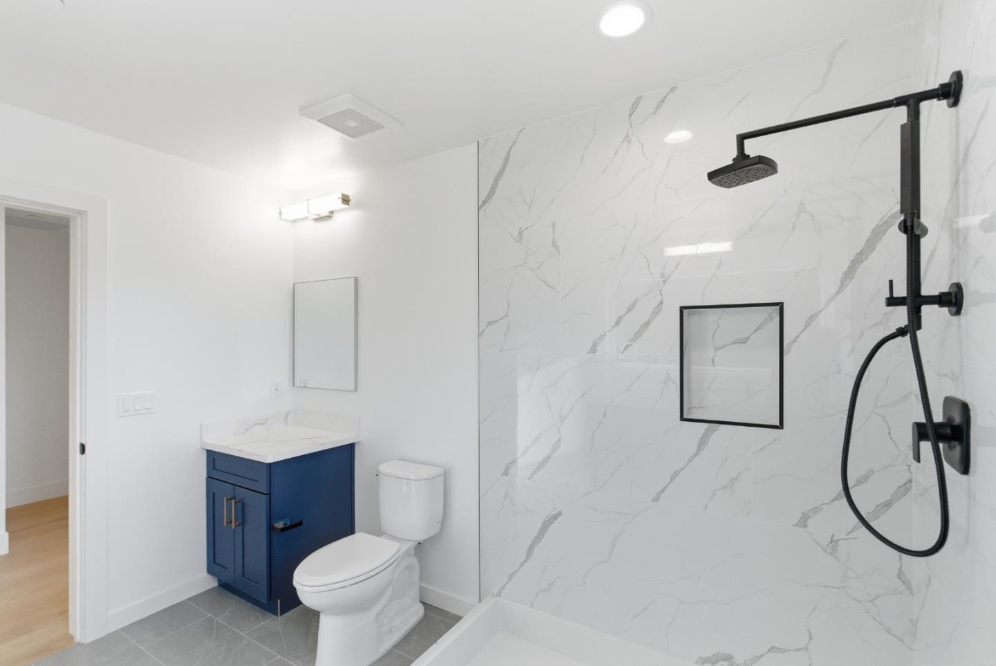 560 El Camino Real, Unit 406 San Carlos, CA 94070 - Photo 31 of 48 a bathroom with a toilet sink and mirror