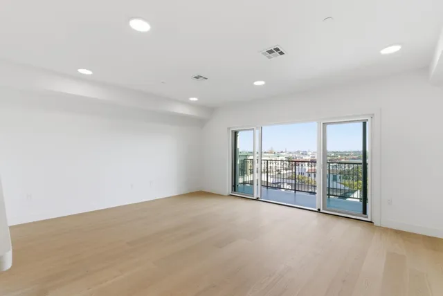 an empty room with floor to ceiling window