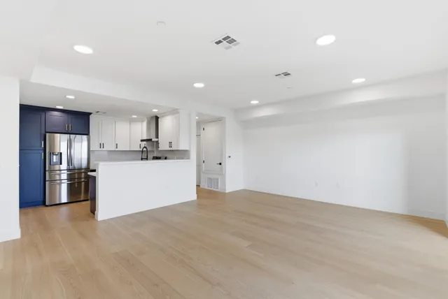 a view of a kitchen with a sink and a refrigerator