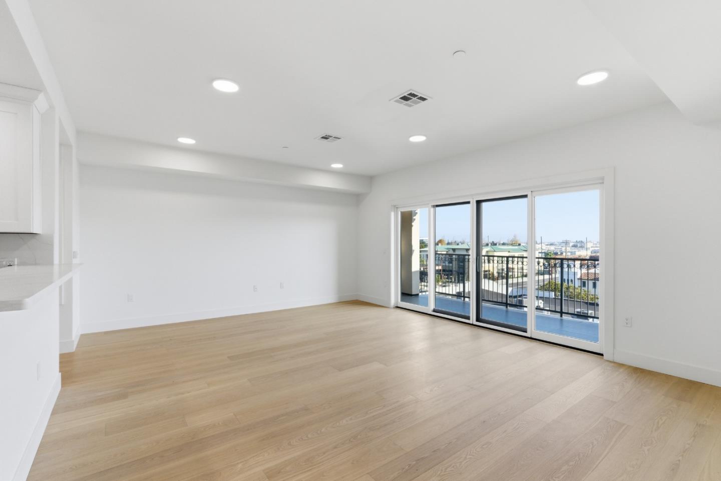 560 El Camino Real, Unit 406 San Carlos, CA 94070 - Photo 8 of 48 an empty room with wooden floor and balcony
