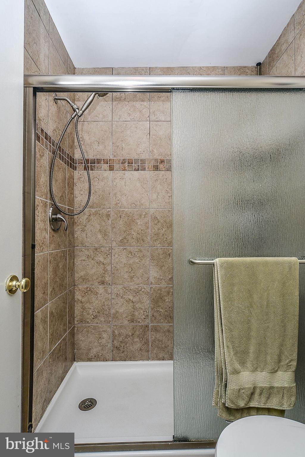 11634 Newbridge Court Reston, VA 20191 - Photo 20 of 25 Bathrooms have floor to ceiling tile in showers