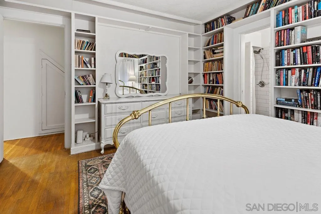 4531 Date Avenue La Mesa, CA 91941 - Photo 16 of 34 a bedroom with a bed and a book shelf