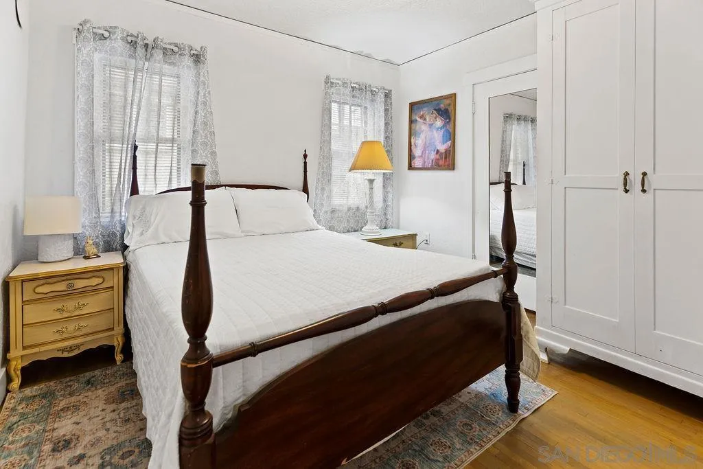 4531 Date Avenue La Mesa, CA 91941 - Photo 18 of 34 a bedroom with a bed wooden floor and window