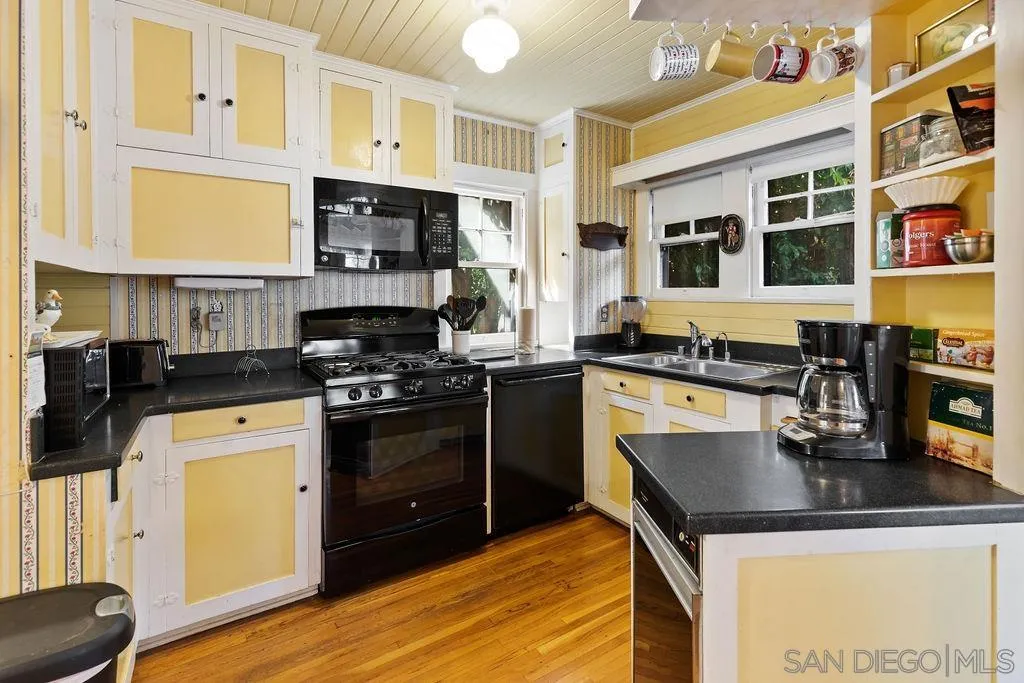 4531 Date Avenue La Mesa, CA 91941 - Photo 4 of 34 a kitchen with a sink a stove and cabinets