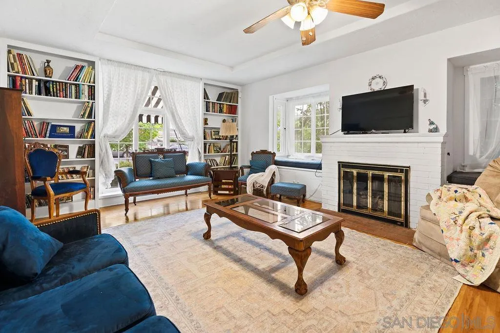 4531 Date Avenue La Mesa, CA 91941 - Photo 9 of 34 a living room with furniture a flat screen tv and a fireplace