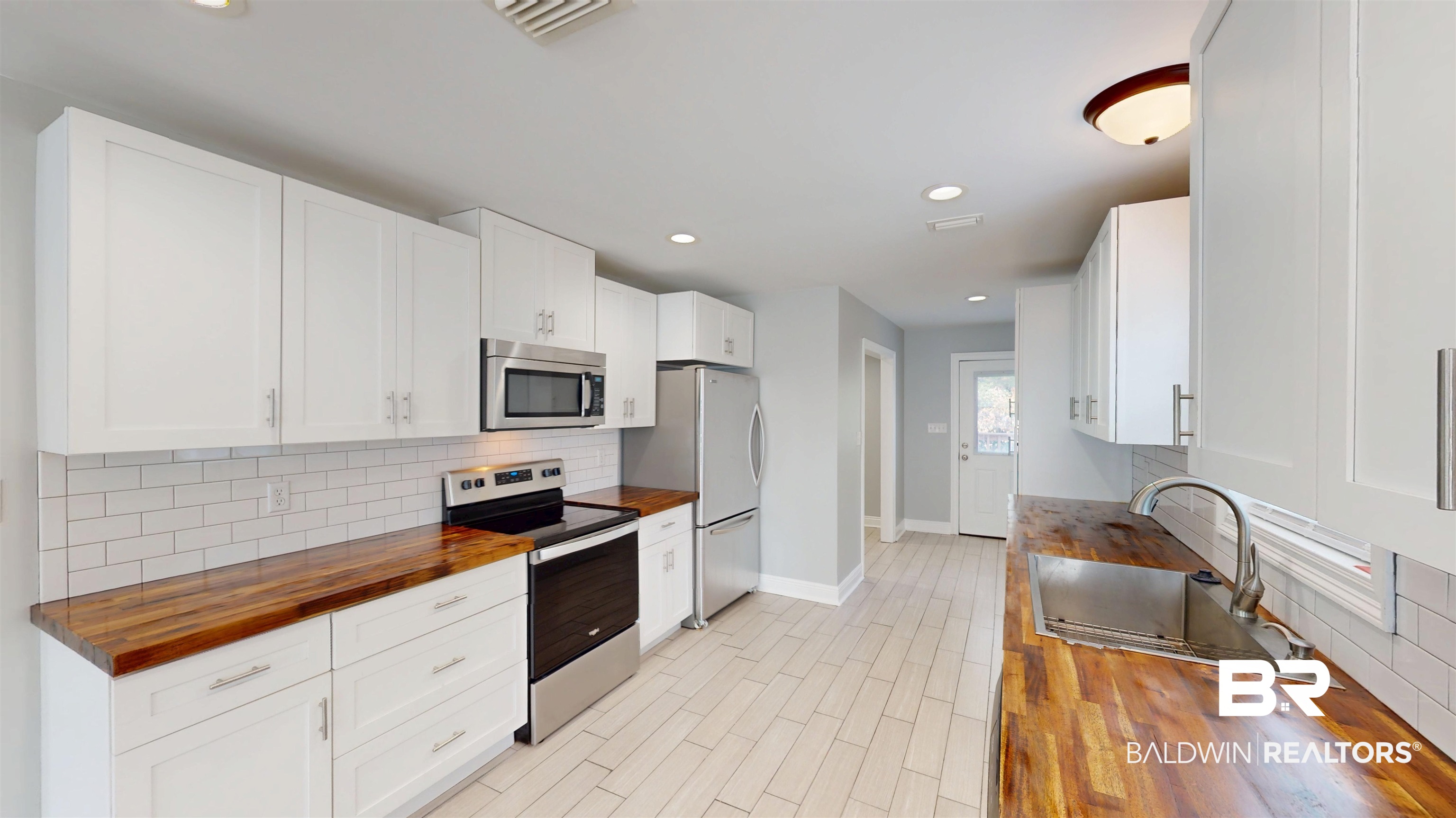 2454 Taylor Avenue Mobile, AL 36606 - Photo 9 of 24 Kitchen featuring wooden counters, stainless steel appliances, white cabinetry, recessed lighting, and light wood-style floors
