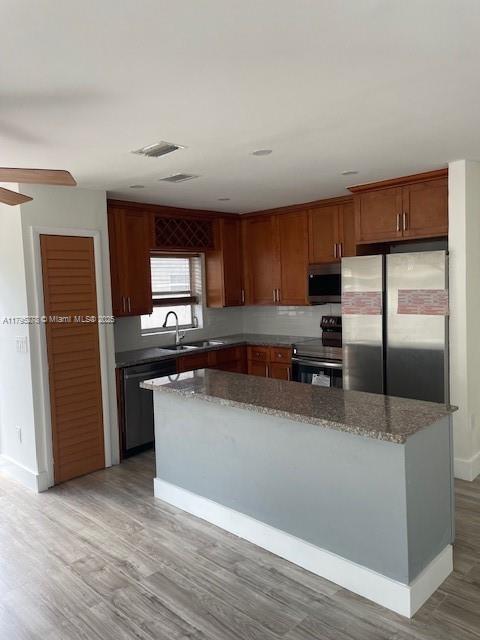 5209 Northwest 18th Street, Unit 3E Lauderhill, FL 33313 - Photo 3 of 8 a kitchen with granite countertop a refrigerator and a stove top oven