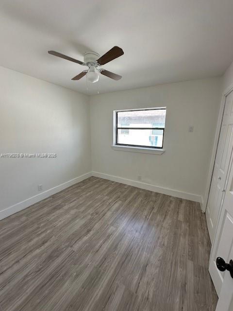 5209 Northwest 18th Street, Unit 3E Lauderhill, FL 33313 - Photo 4 of 8 an empty room with wooden floor and windows