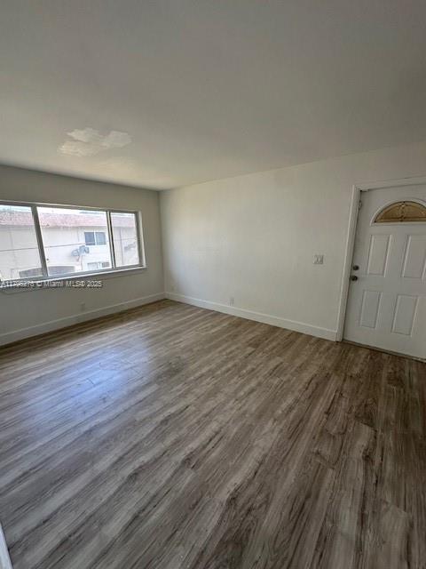 5209 Northwest 18th Street, Unit 3E Lauderhill, FL 33313 - Photo 7 of 8 an empty room with wooden floor and windows