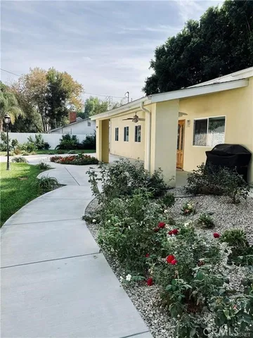 a front view of a house with a garden