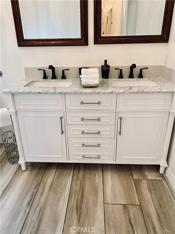 19238 Arminta Street Reseda, CA 91335 - Photo 15 of 61 a bathroom with a double vanity sink and mirror