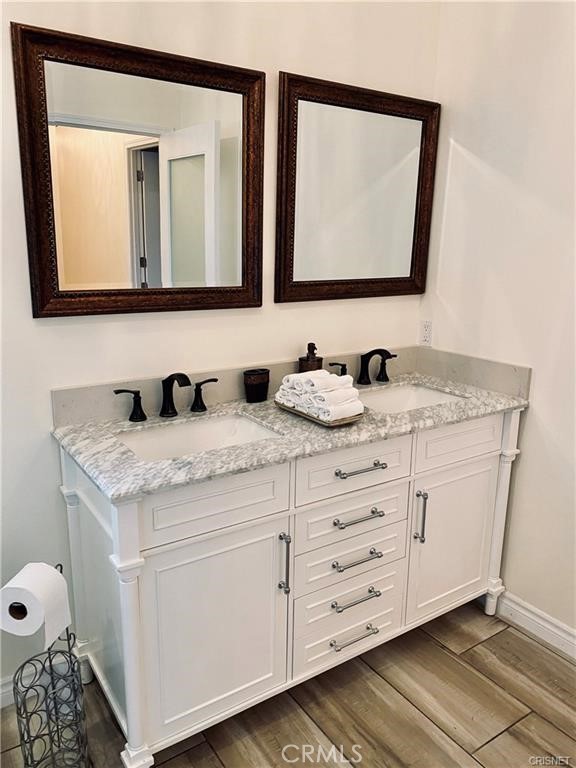 19238 Arminta Street Reseda, CA 91335 - Photo 18 of 61 a bathroom with a granite countertop sink and a mirror