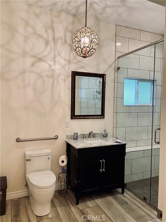 19238 Arminta Street Reseda, CA 91335 - Photo 19 of 61 a bathroom with a toilet sink and mirror