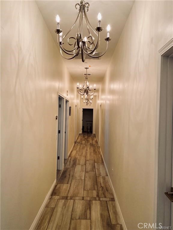 19238 Arminta Street Reseda, CA 91335 - Photo 20 of 61 a view of a hallway with a chandelier