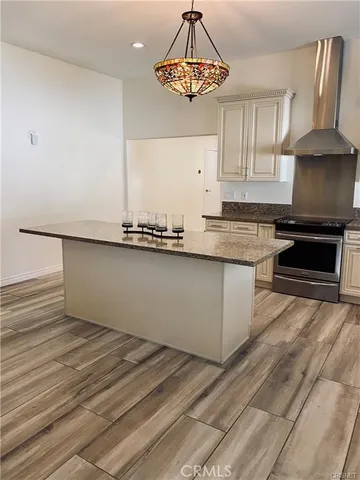 a kitchen with granite countertop a sink stainless steel appliances and cabinets