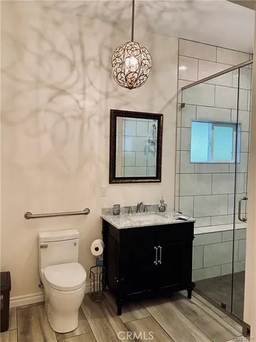 a white painted wall with a painting on it