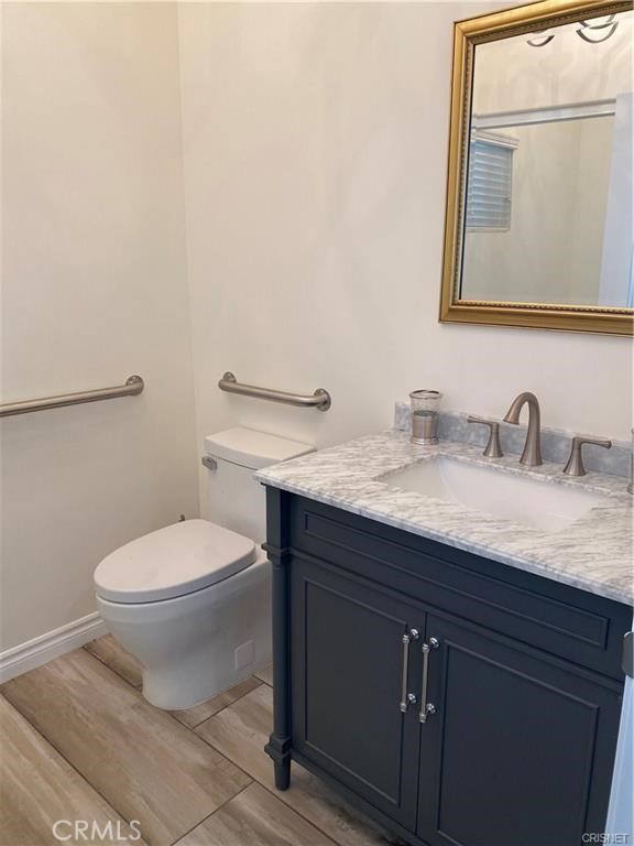 19238 Arminta Street Reseda, CA 91335 - Photo 44 of 61 a bathroom with a granite countertop toilet sink and mirror