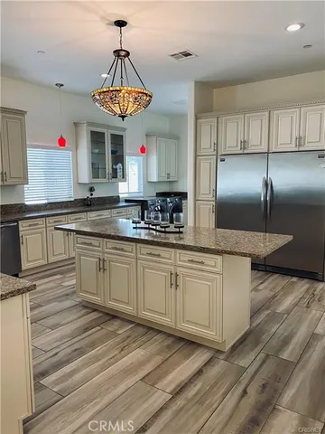 a kitchen with stainless steel appliances granite countertop a sink counter space and cabinets