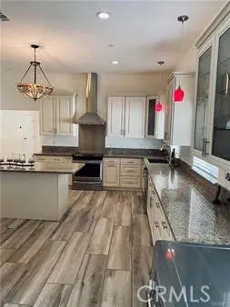 a kitchen with stainless steel appliances granite countertop a sink a counter top space cabinets and window