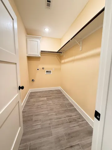 a view of a room with wooden floor