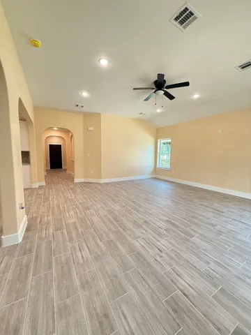 a view of a kitchen with a sink and a chandelier fan