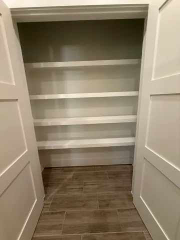 a view of walk in closet with empty racks