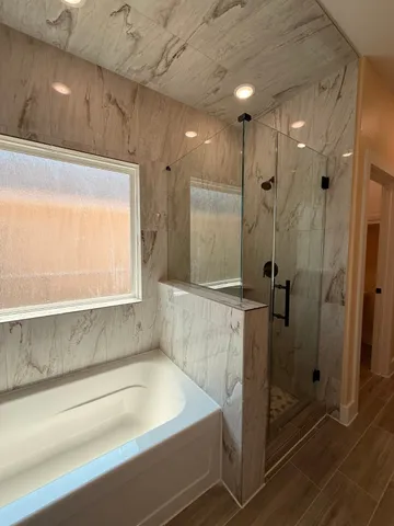 a bathroom with a bathtub and a shower