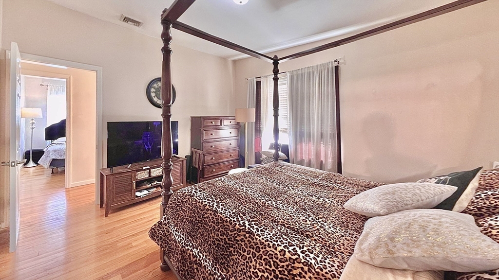 10 Milton Ridge Road, Unit 10 Lynn, MA 01902 - Photo 14 of 33 a bedroom with a bed and a flat screen tv